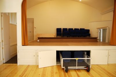 Stage showing storage under, corridor to green room behind and blocks on stage that extend stage over corridor